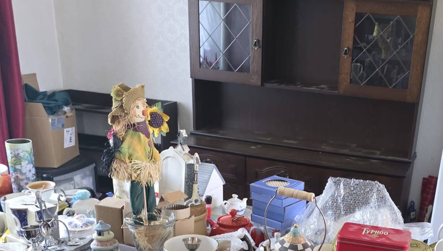 Ornaments, tins and china from a home, sorted and set out on a table