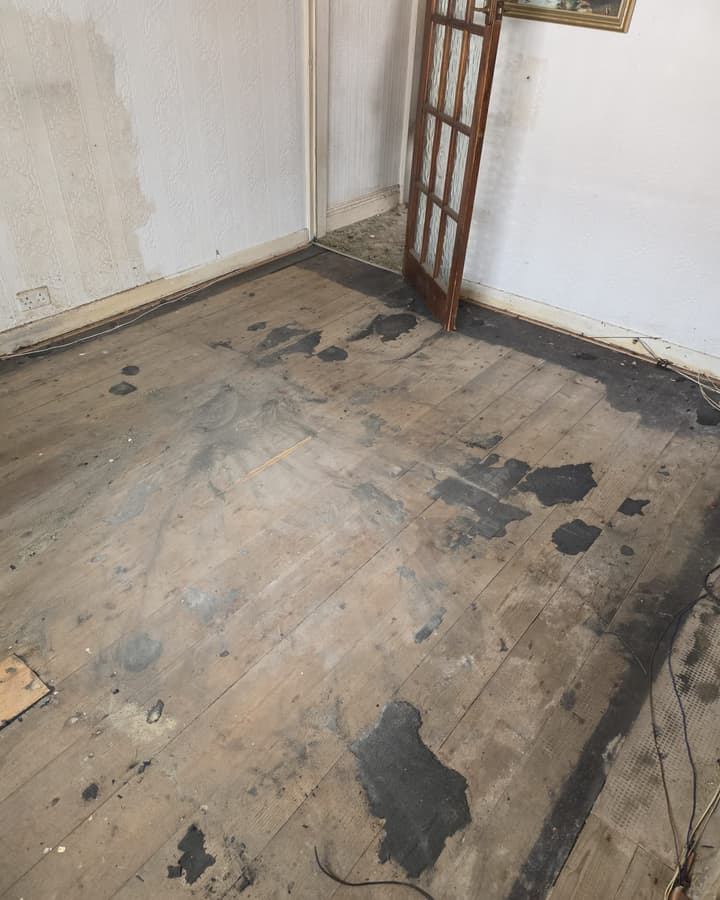 A cleared room with bare floorboards